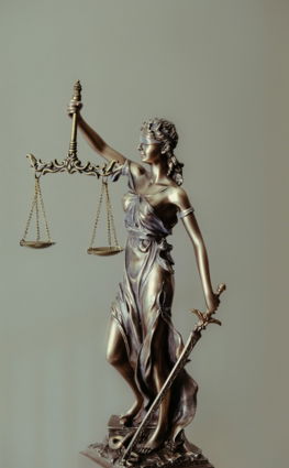 woman in gold dress holding sword figurine
